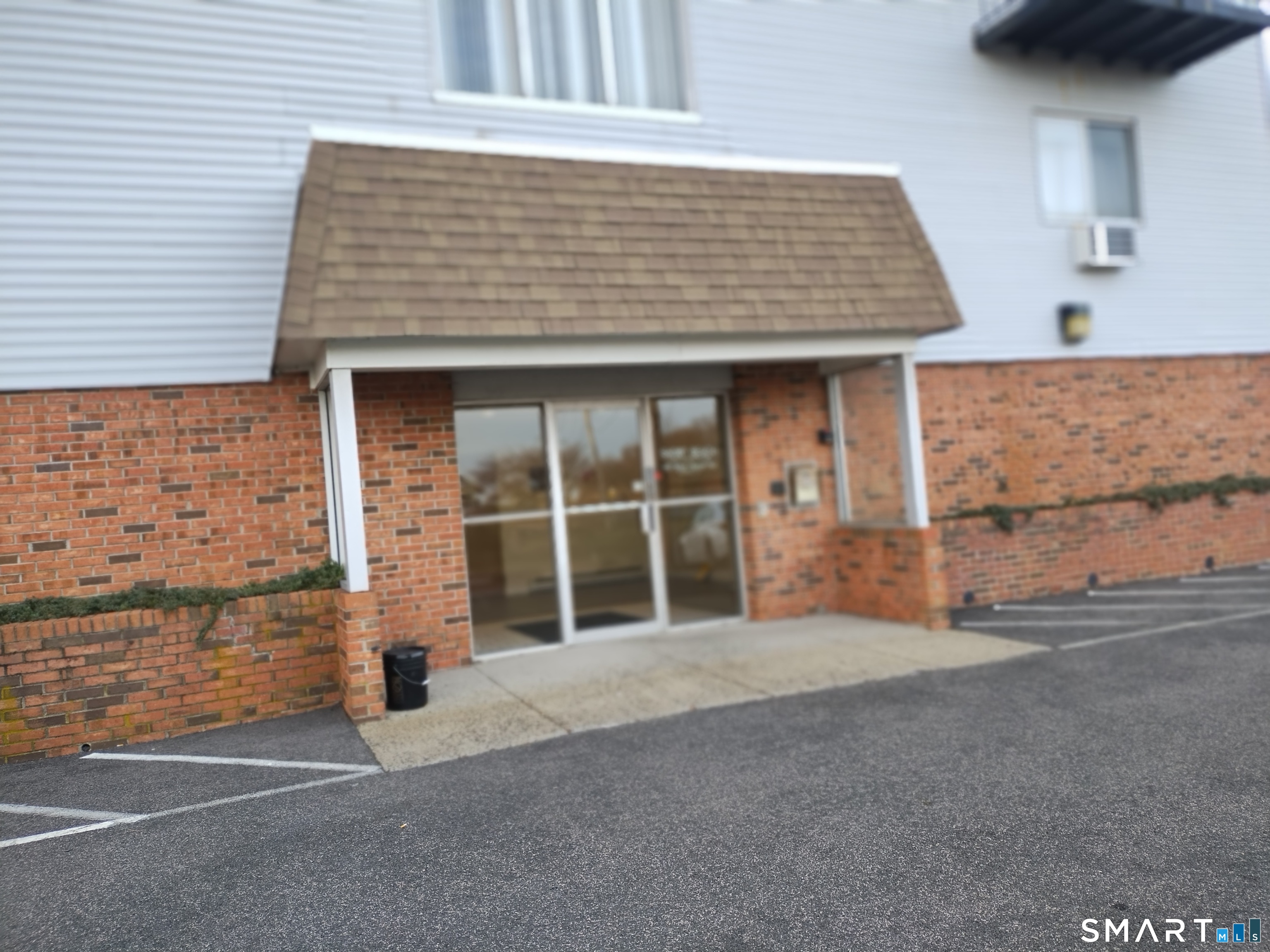 115 Short Beach Road, Unit 307 Stratford, CT 06615 - Photo 2 of 32 a front view of a house with a garage