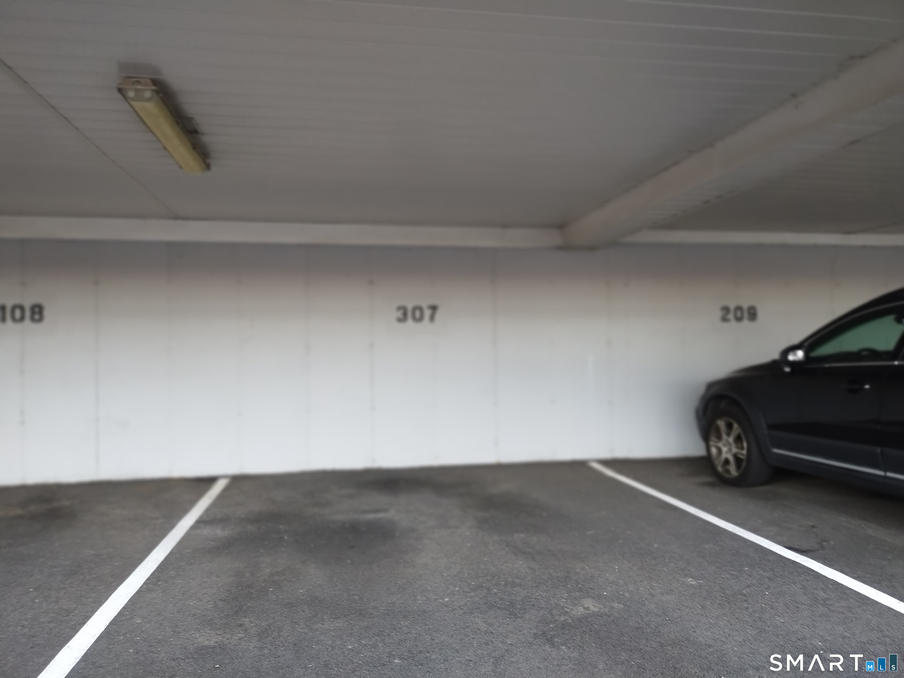 115 Short Beach Road, Unit 307 Stratford, CT 06615 - Photo 30 of 32 a view of room with a car parked