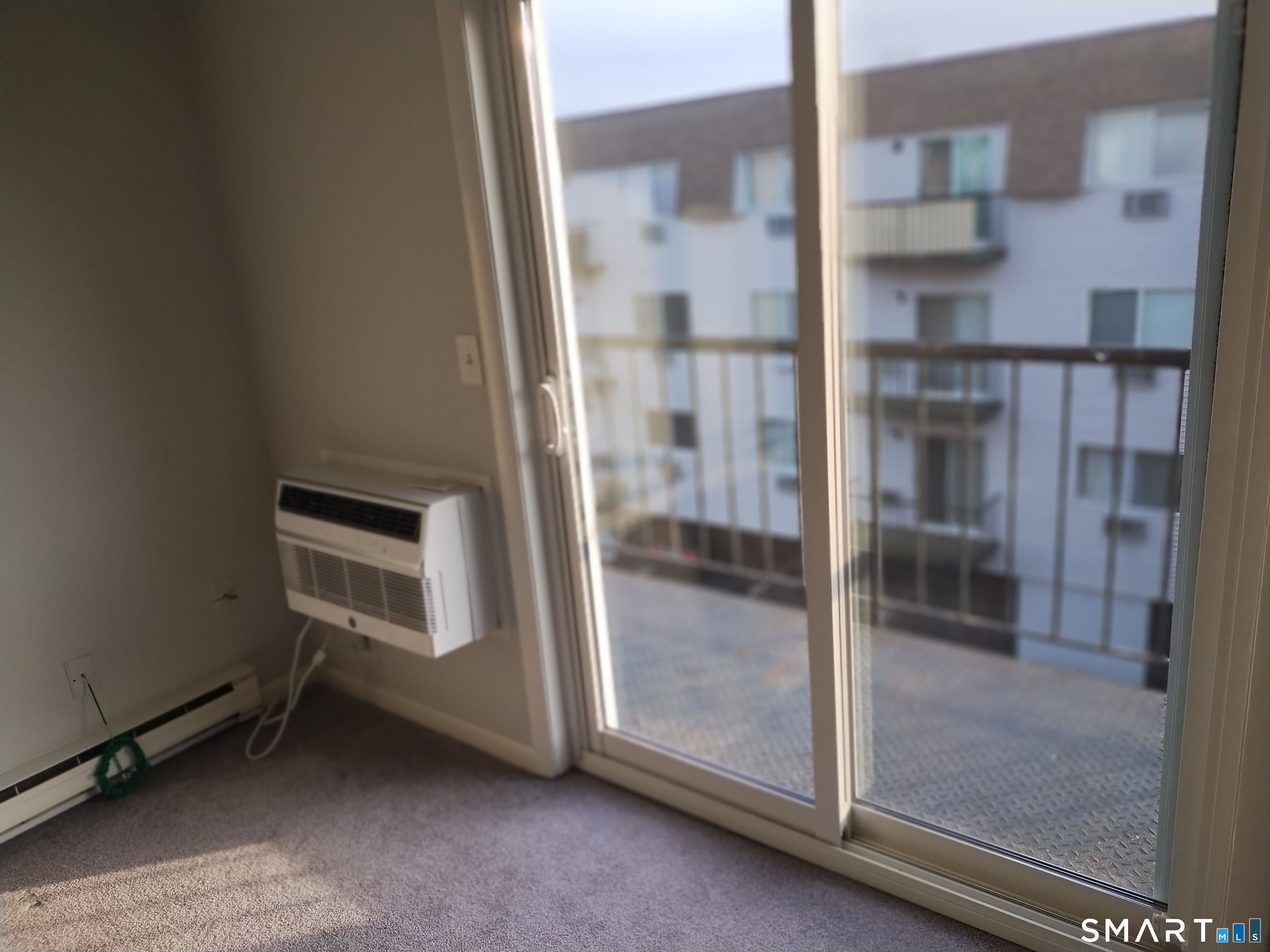 115 Short Beach Road, Unit 307 Stratford, CT 06615 - Photo 8 of 32 a room with wooden floor and brick walls