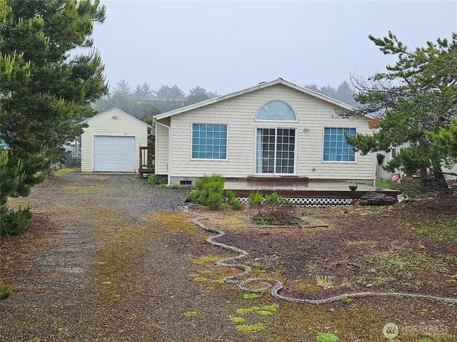 a view of front of a house with a yard and garage
