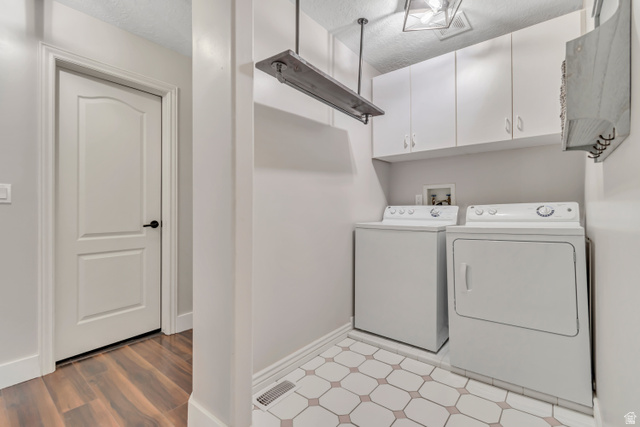 2154 Wasatch Boulevard Sandy, UT 84092 - Photo 8 of 55 Washroom with a textured ceiling, independent washer and dryer, cabinet space, and light wood-style flooring
