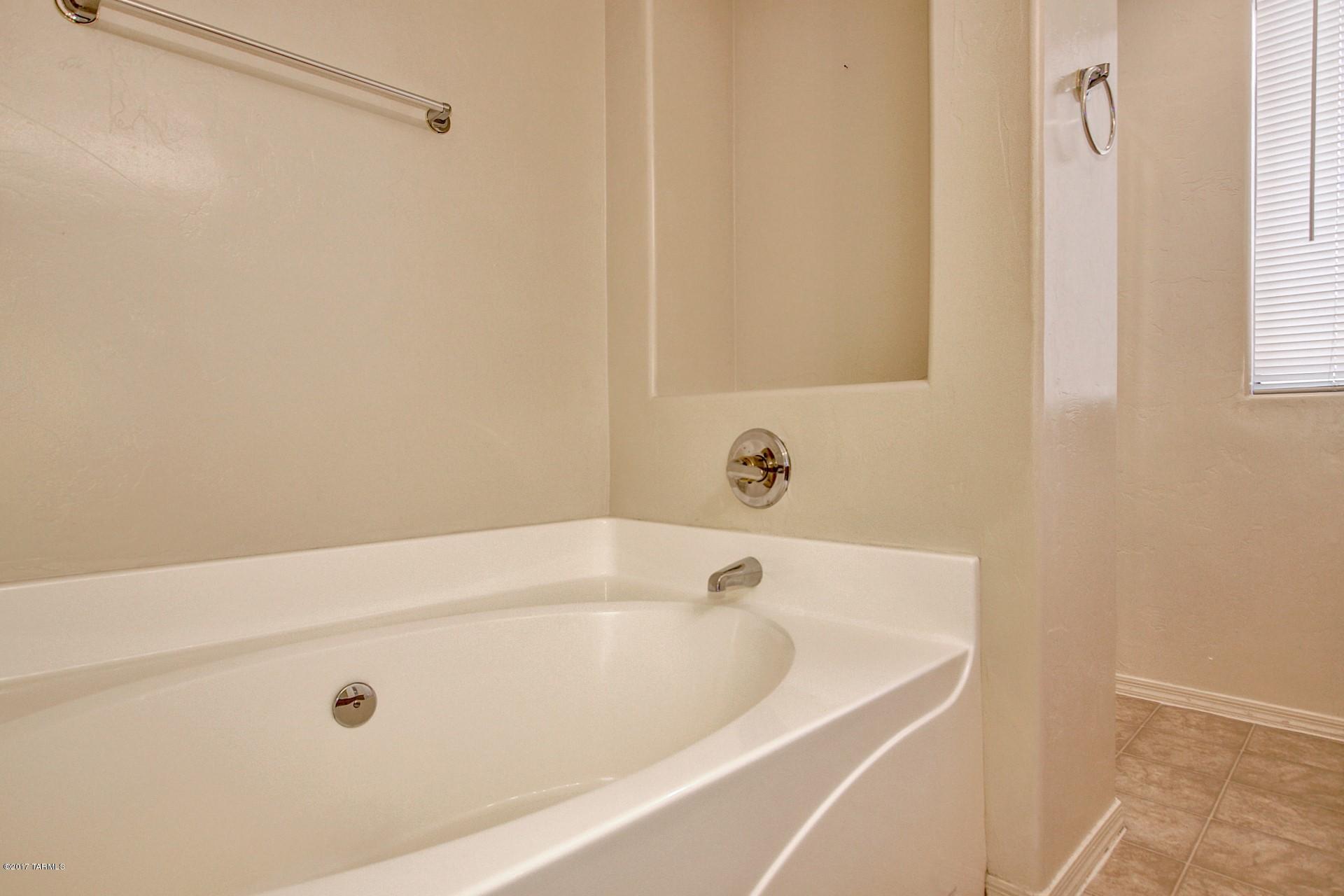8350 East Bowline Road Tucson, AZ 85710 - Photo 15 of 26 a bathroom with a tub and a shower