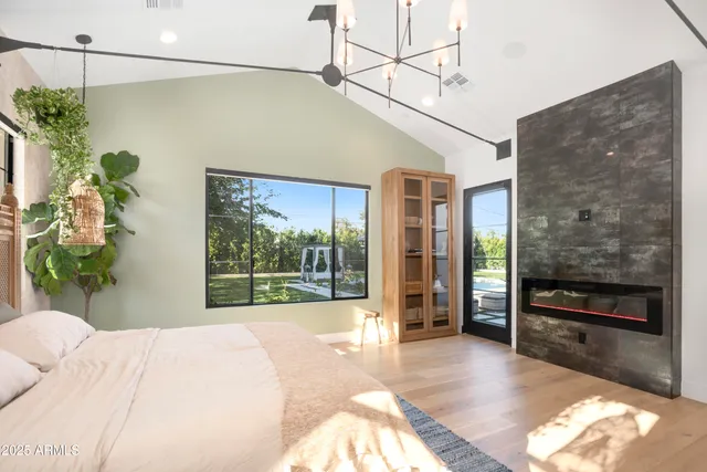a bedroom with a bed lamp closet and large window