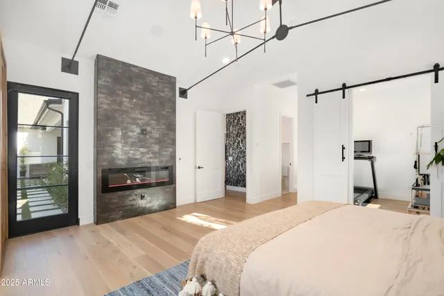 a bedroom with furniture and large windows