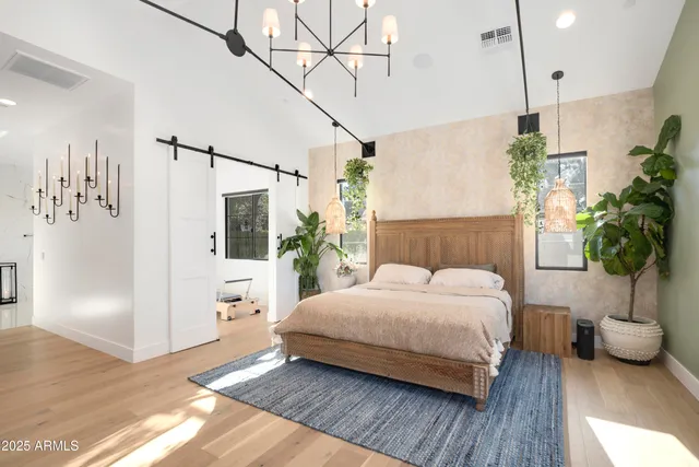 a bedroom with a bed dresser and a window