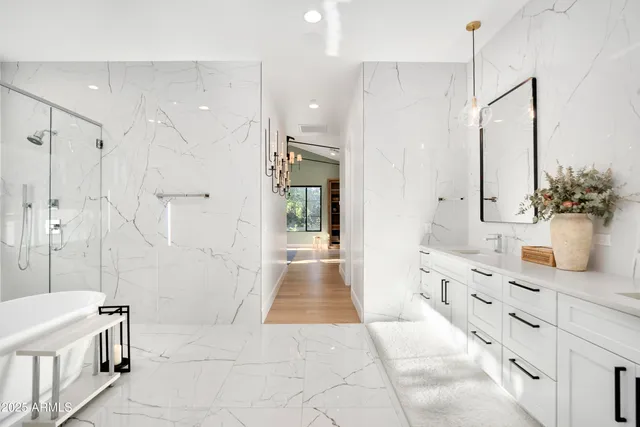 a bedroom with a large bed and a potted plant