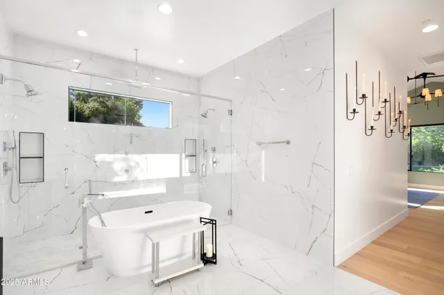 a bathroom with a tub sink and mirror