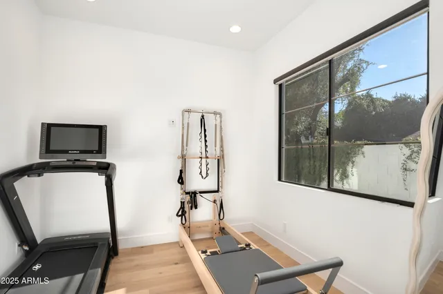 a kitchen with a refrigerator and white cabinets