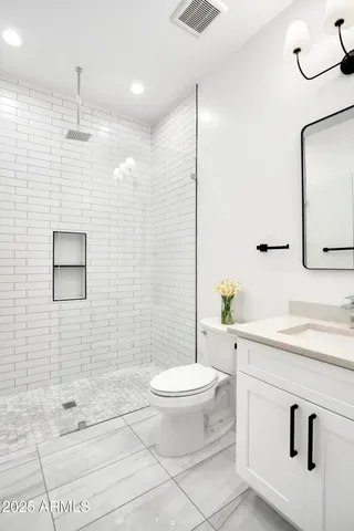 a bedroom with a bed and a large mirror