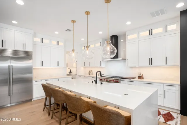 a large kitchen with a table and chairs