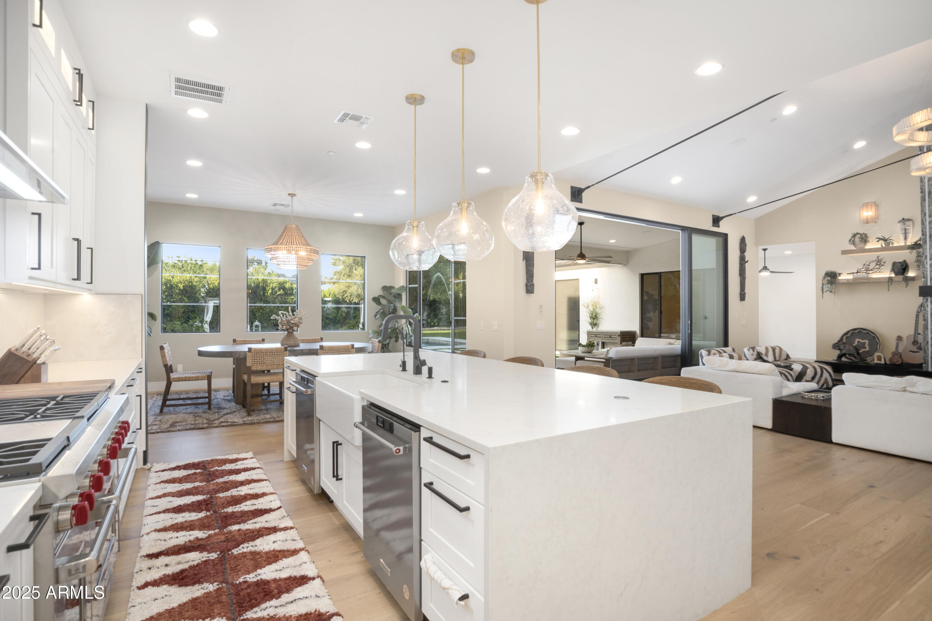 2912 East Pierson Street Phoenix, AZ 85016 - Photo 9 of 39 a large kitchen with kitchen island a stove a sink a dining table and chairs