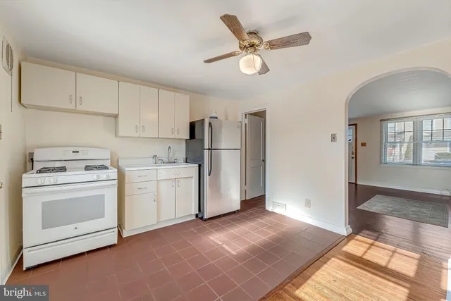 a view of a kitchen with refrigerator and microwave