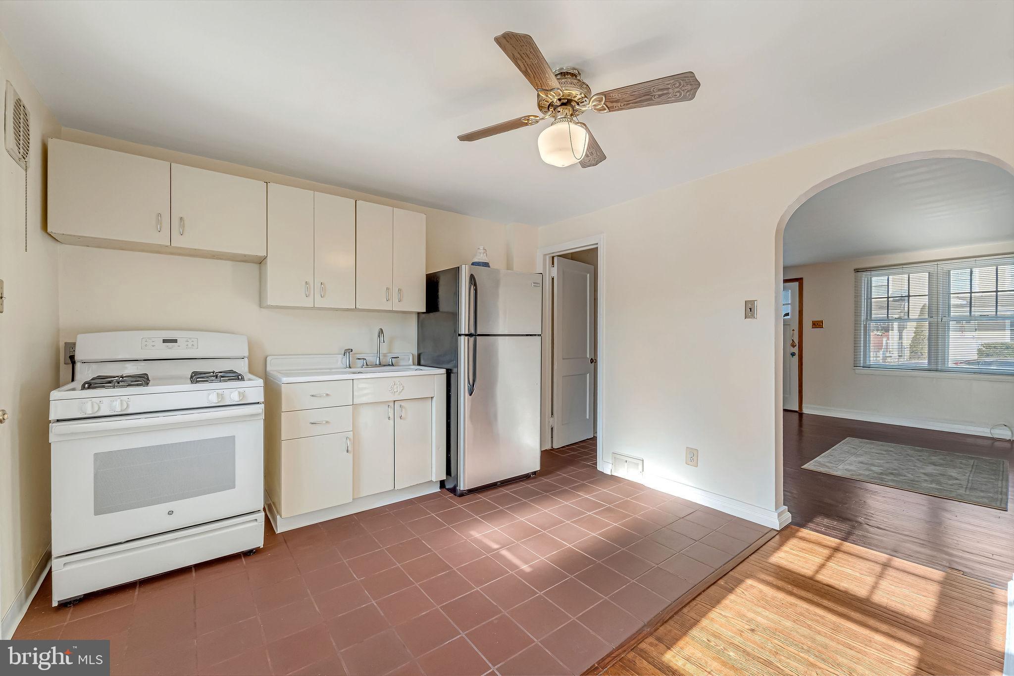 1105 North 21st Street Camden, NJ 08105 - Photo 7 of 15 a view of a kitchen with refrigerator and microwave