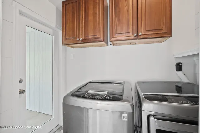 a view of an empty room with wooden floor and a balcony