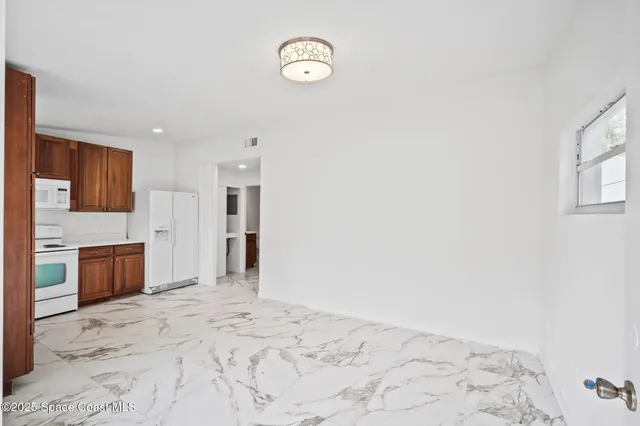 a kitchen with stainless steel appliances granite countertop a refrigerator sink and cabinets