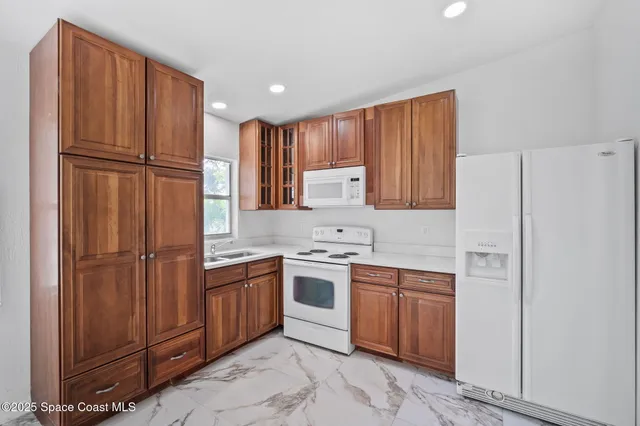a bathroom with a sink toilet vanity and shower