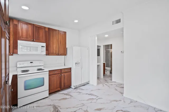 a view of a big room with wooden floor and a ceiling fan