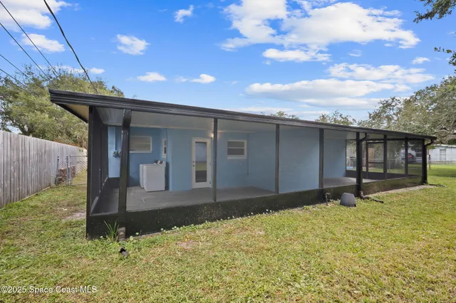 a house view with swimming pool in front of it