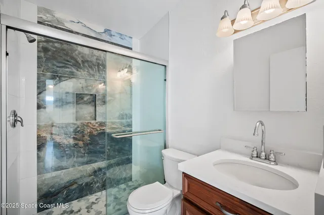 a view of a big room with wooden floor and a ceiling fan