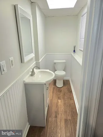 a white toilet sitting next to a bathroom sink