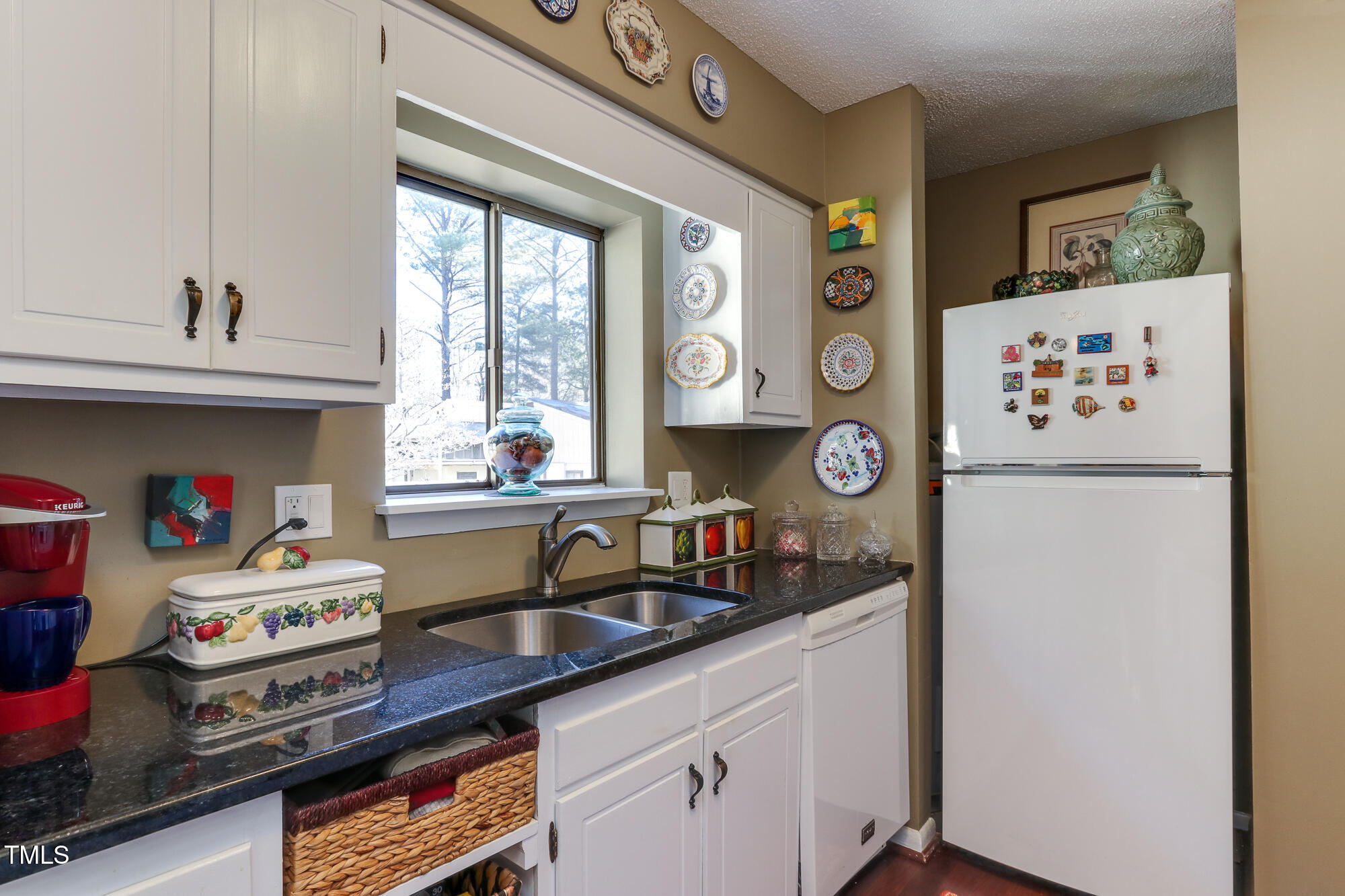 615 Pine Ridge Place Raleigh, NC 27609 - Photo 7 of 22 a kitchen with a refrigerator and a sink