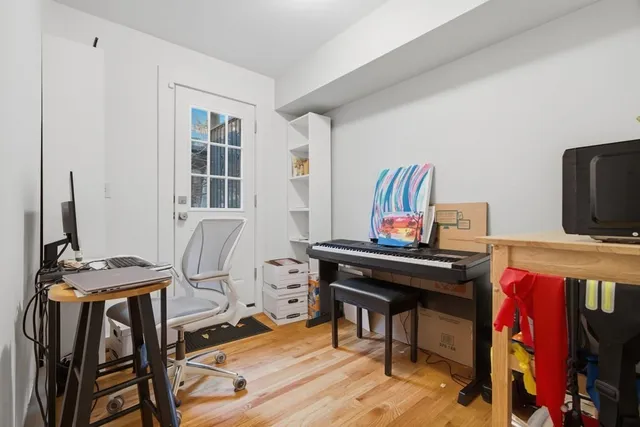 a view of a workspace with furniture and a window