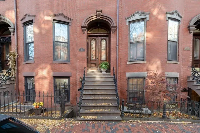 a view of a brick house with many windows