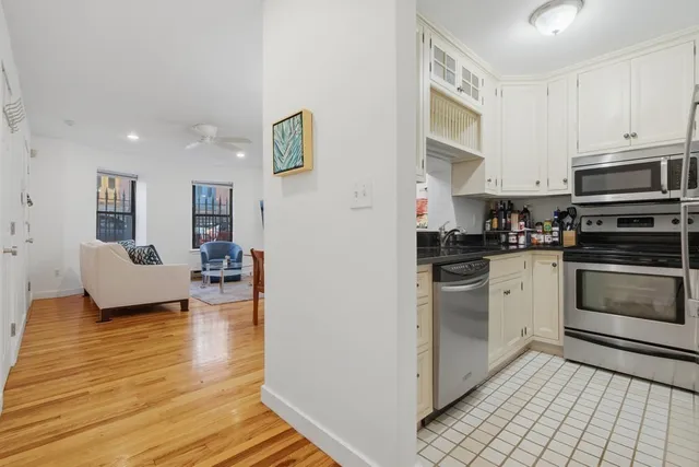 a kitchen with stainless steel appliances a stove a sink and a refrigerator