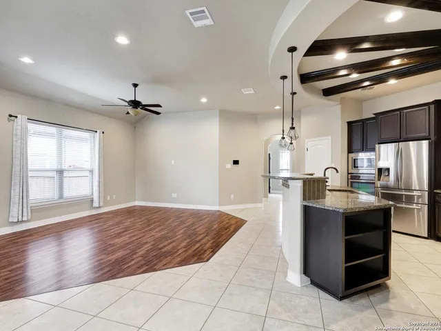 a view of kitchen with stainless steel appliances kitchen island granite countertop a refrigerator oven a sink and dishwasher