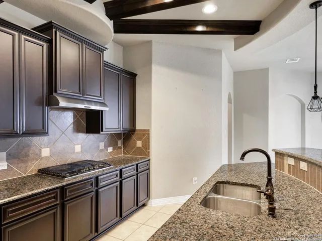 a kitchen with granite countertop stainless steel appliances and a counter top