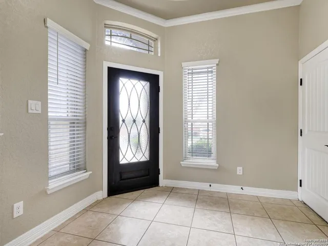 an empty room with windows and mirror