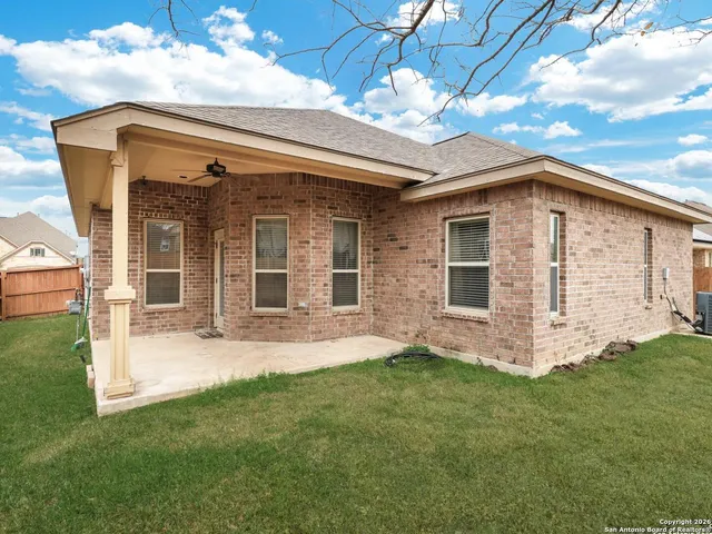a view of a house with backyard and porch