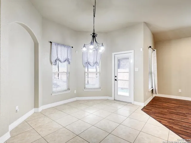 a view of a room with window and chandelier fan