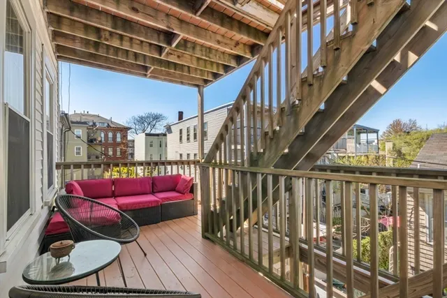 a view of a backyard with a patio and wooden fence