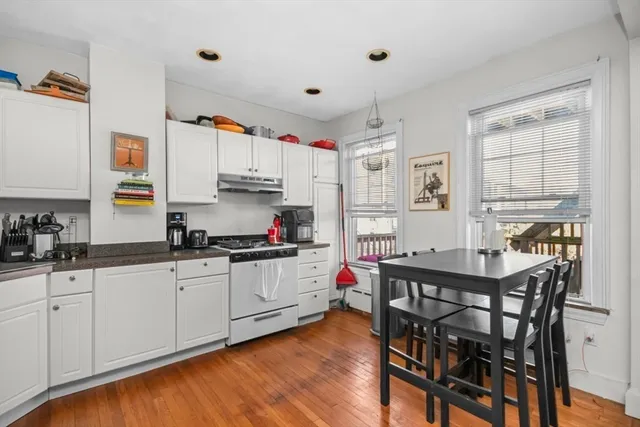 a kitchen with white cabinets and white appliances