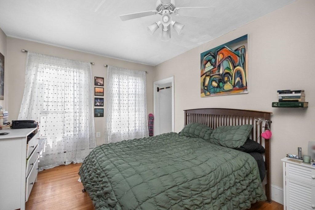 508 East 3rd Street, Unit 2 Boston, MA 02127 - Photo 9 of 17 a bedroom with a bed and a chandelier