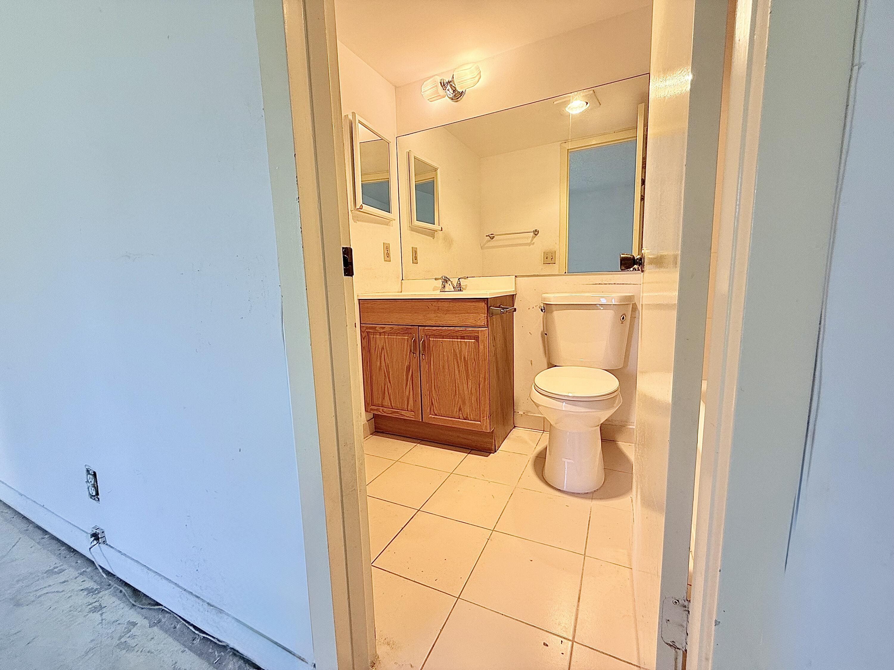 13 Dorset A Boca Raton, FL 33434 - Photo 30 of 69 a bathroom with a sink toilet and shower