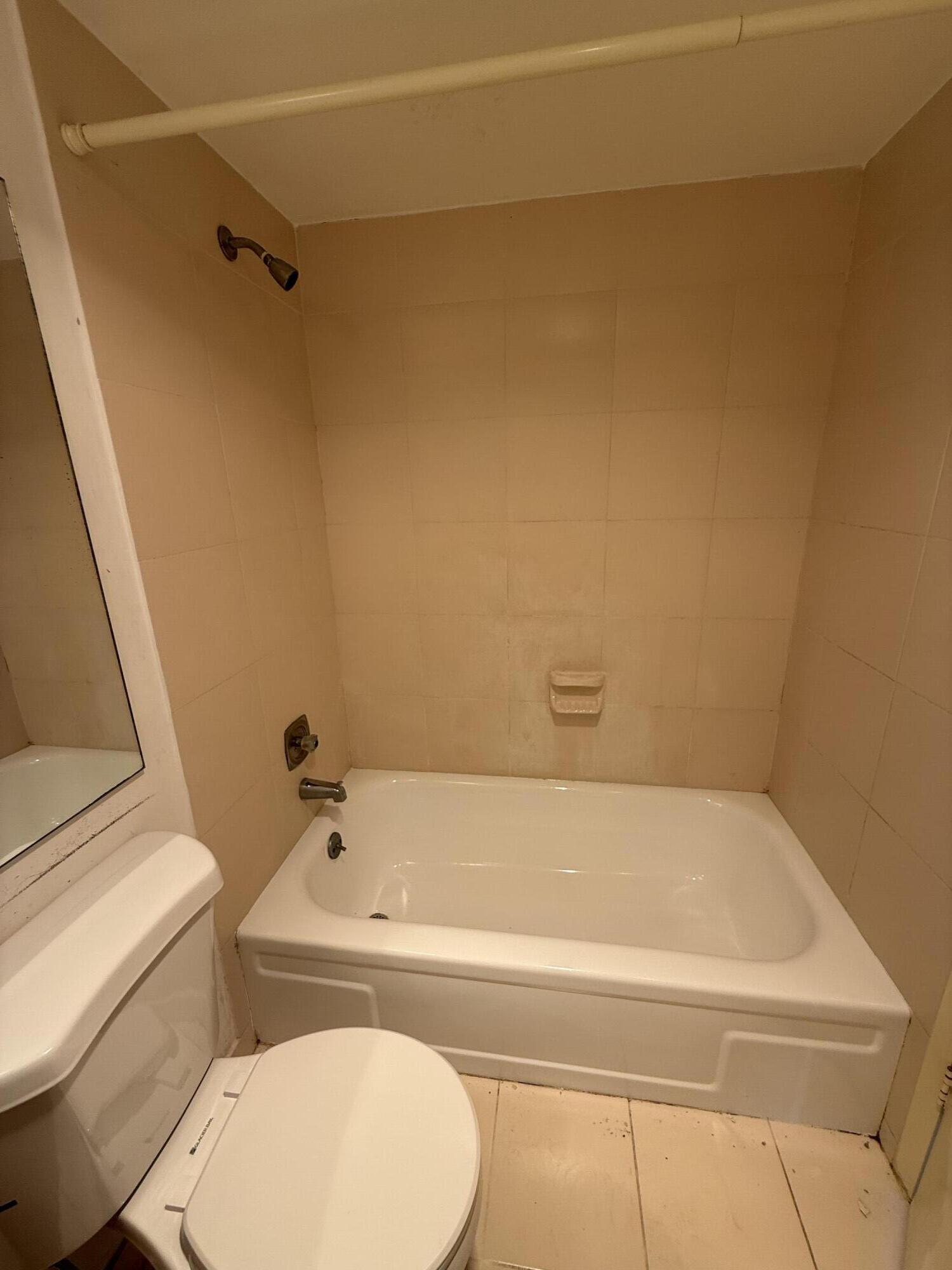 13 Dorset A Boca Raton, FL 33434 - Photo 31 of 69 a bathroom with a bathtub and toilet