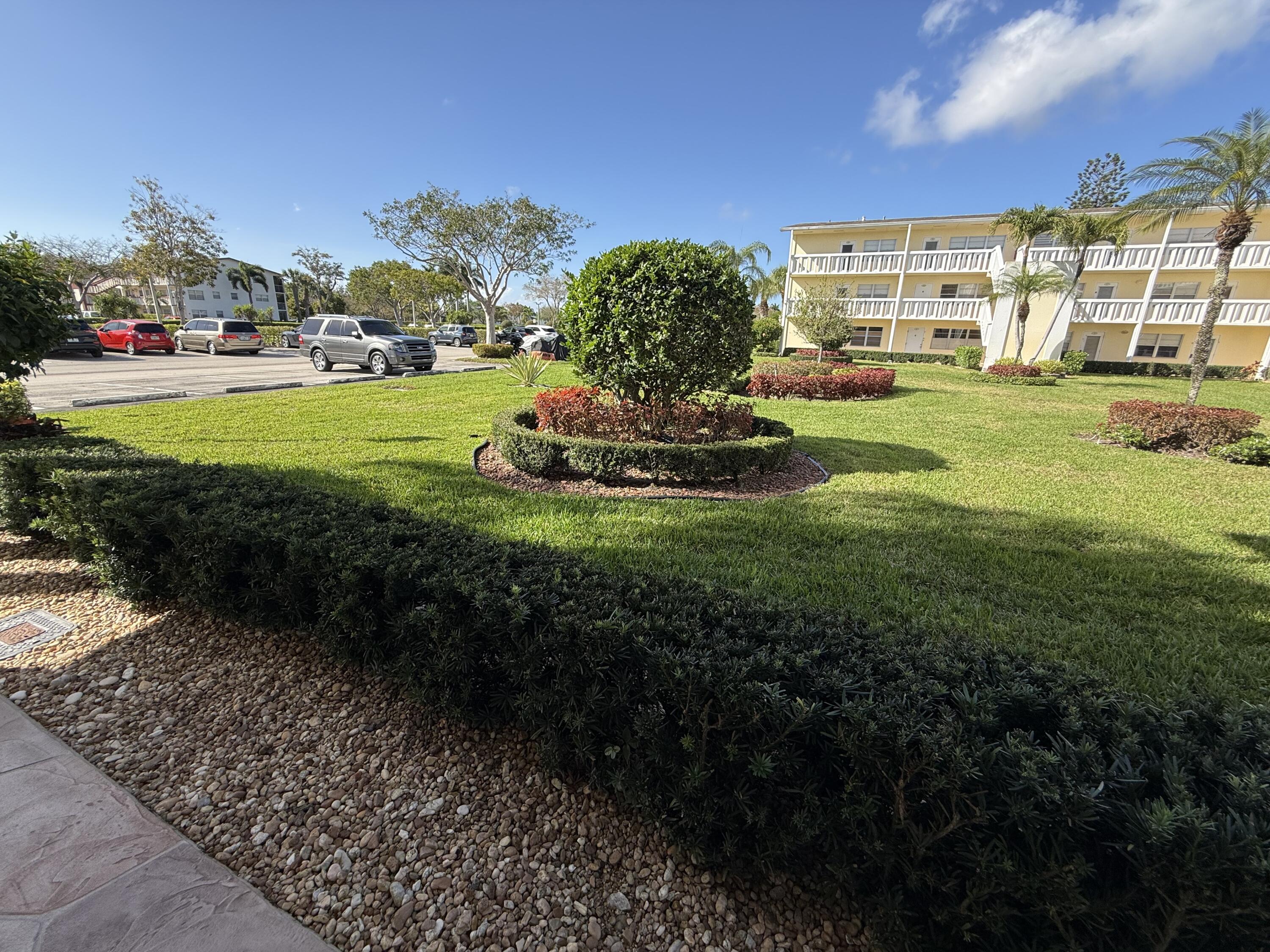 13 Dorset A Boca Raton, FL 33434 - Photo 38 of 69 a view of a big yard with a building in the background