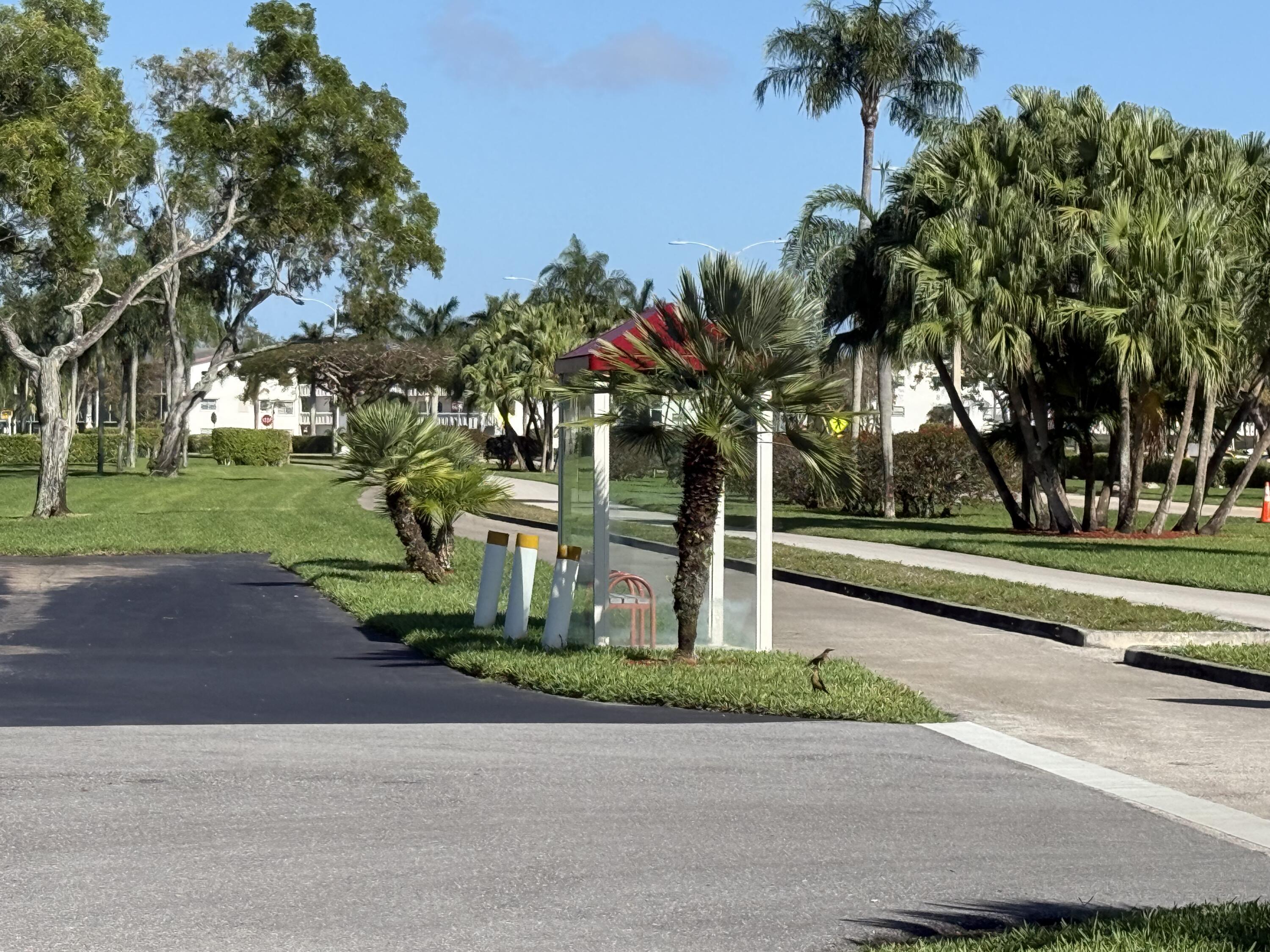 13 Dorset A Boca Raton, FL 33434 - Photo 47 of 69 a front view of multi story residential apartment building with yard and green space