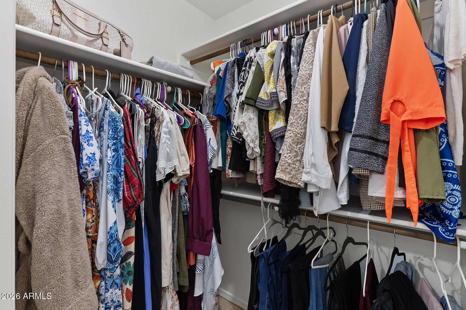 9002 West Coronado Road Phoenix, AZ 85037 - Photo 29 of 54 a view of walk in closet with clothes