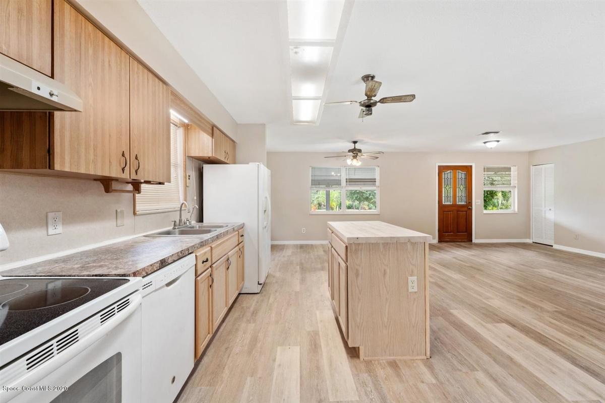 3600 Leghorn Road Grant Valkaria, FL 32950 - Photo 6 of 33 a kitchen with a stove a sink and a refrigerator