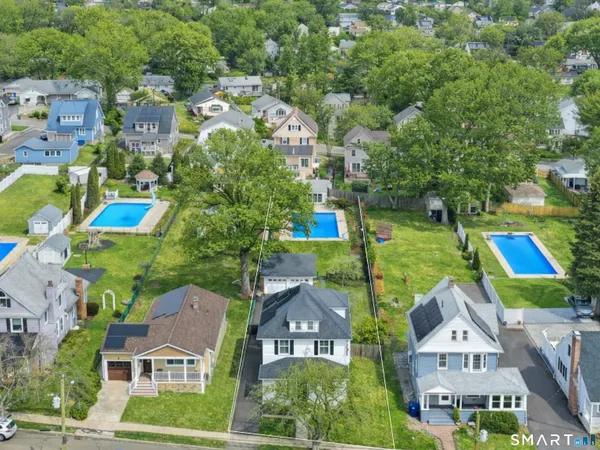 an aerial view of multiple houses with yard