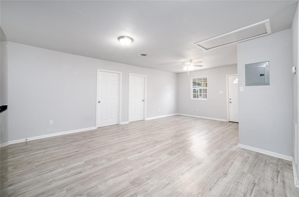 1309 Jefferson Street, Unit C Baytown, TX 77520 - Photo 3 of 9 an empty room with wooden floor and windows