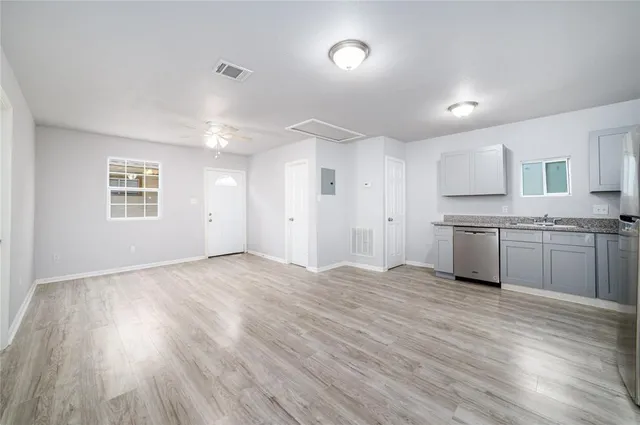 a view of a kitchen with a sink and a window