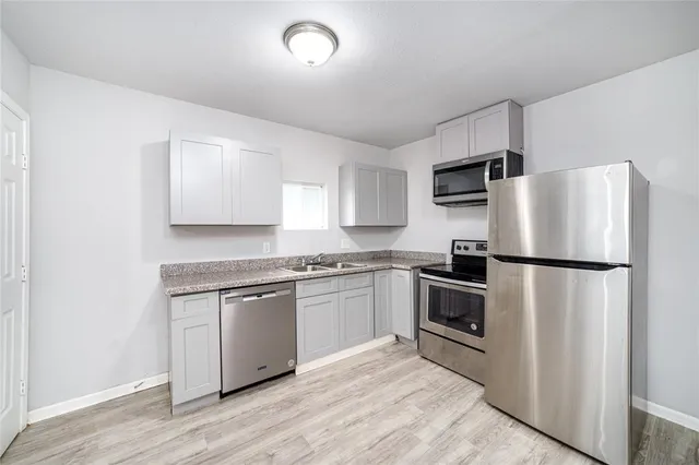 a kitchen with a refrigerator stove and sink