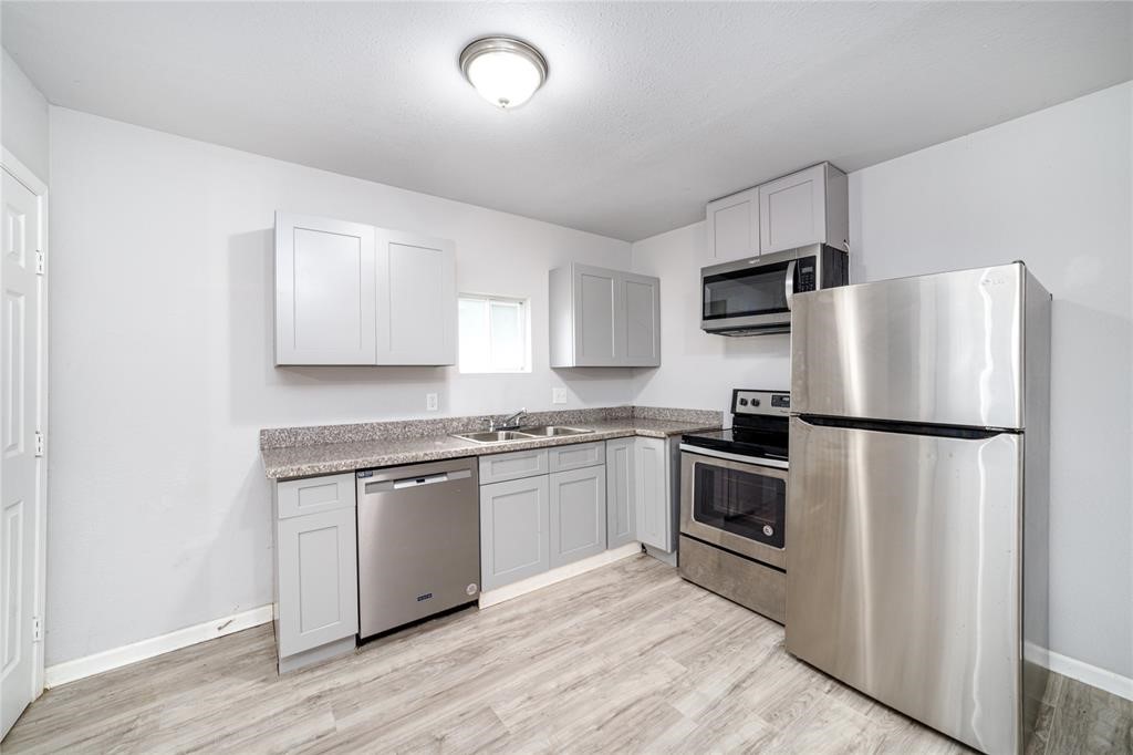 1309 Jefferson Street, Unit C Baytown, TX 77520 - Photo 6 of 9 a kitchen with a refrigerator stove and sink