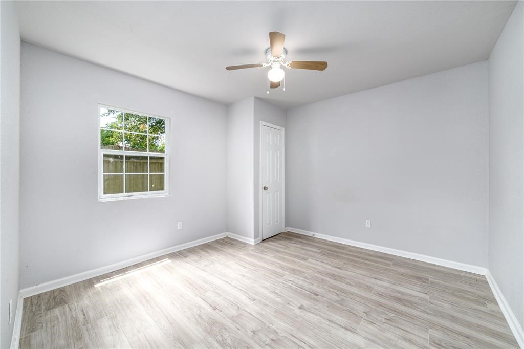 1309 Jefferson Street, Unit C Baytown, TX 77520 - Photo 7 of 9 a view of an empty room with wooden floor and a window
