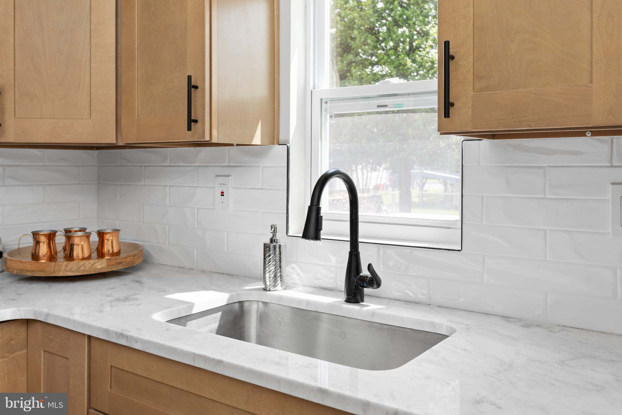 124 Gary Drive Hamilton, NJ 08690 - Photo 13 of 31 a close view of a sink and dishwasher in kitchen with a window