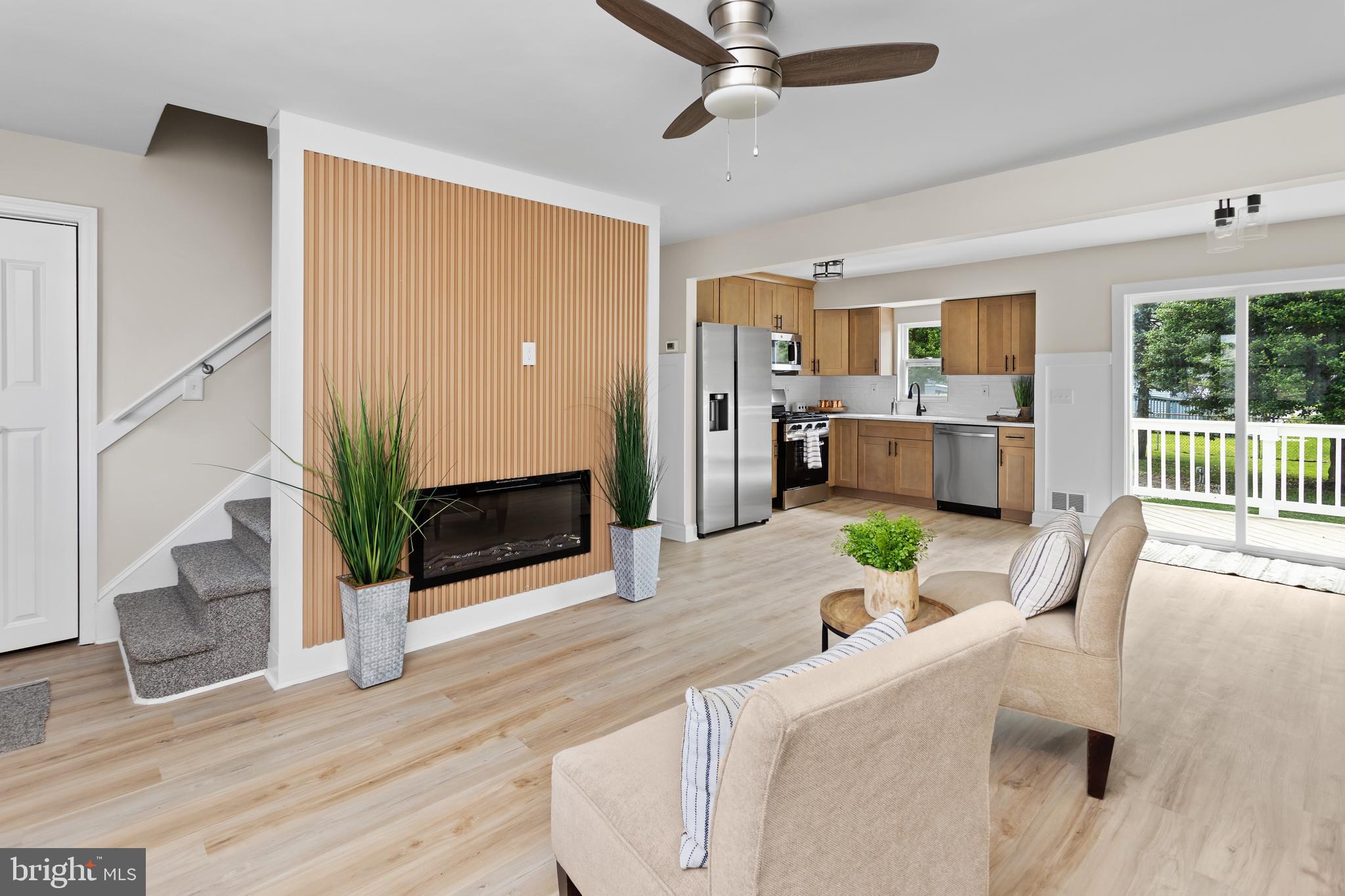 124 Gary Drive Hamilton, NJ 08690 - Photo 6 of 31 a living room with furniture a fireplace and a flat screen tv